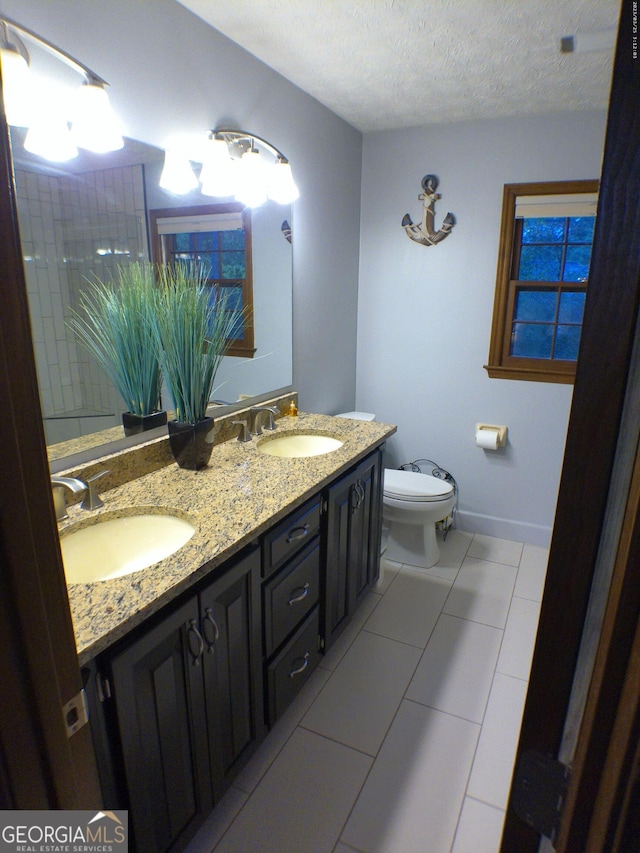 5741 Wolf Laurel Ln SW, Lilburn, GA 30047 - full bathroom with double vanity, a textured ceiling, and tile patterned floors