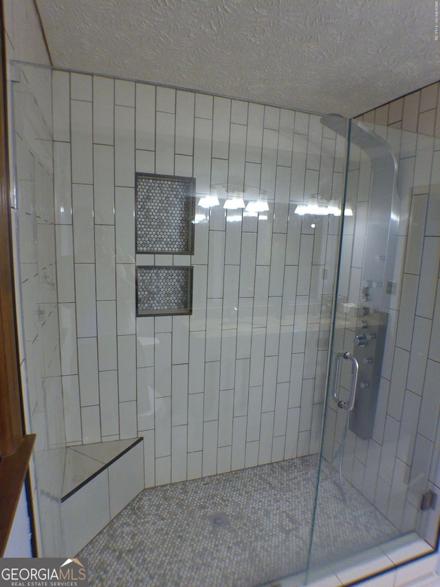 5741 Wolf Laurel Ln SW, Lilburn, GA 30047 - bathroom featuring a shower stall and a textured ceiling