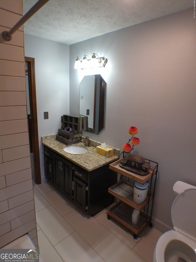 5741 Wolf Laurel Ln SW, Lilburn, GA 30047 - bathroom featuring a textured ceiling, vanity, and tile patterned flooring