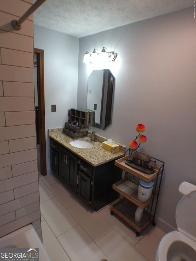 5741 Wolf Laurel Ln SW, Lilburn, GA 30047 - bathroom with vanity, a textured ceiling, tile patterned flooring, and a bath