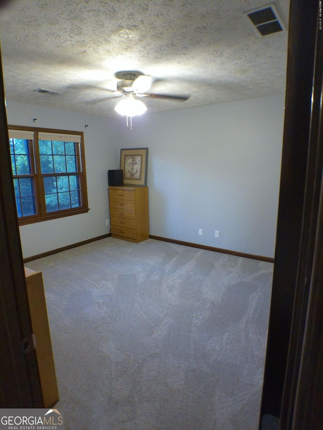 5741 Wolf Laurel Ln SW, Lilburn, GA 30047 - empty room featuring ceiling fan, light carpet, and a textured ceiling