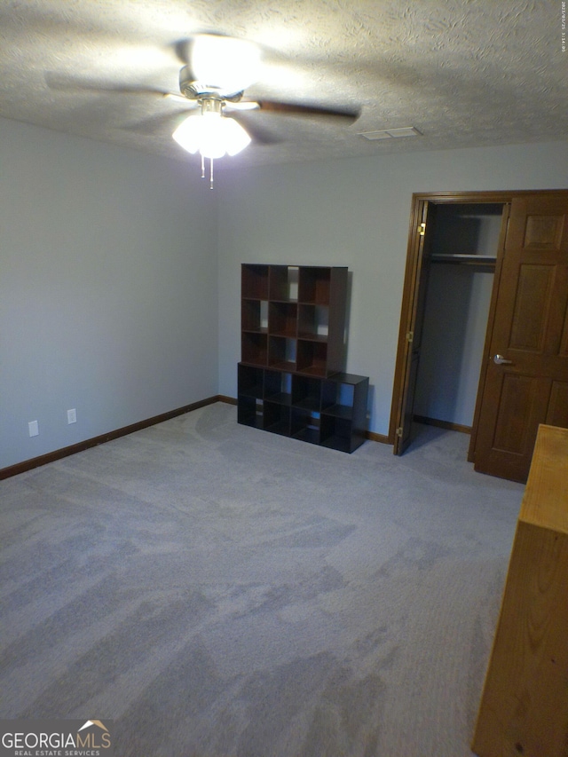 5741 Wolf Laurel Ln SW, Lilburn, GA 30047 - unfurnished bedroom with light carpet, ceiling fan, and a closet