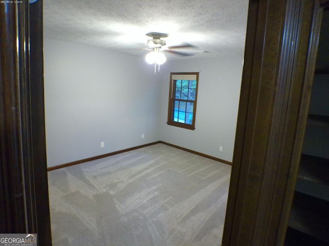 5741 Wolf Laurel Ln SW, Lilburn, GA 30047 - empty room with light carpet, ceiling fan, and a textured ceiling