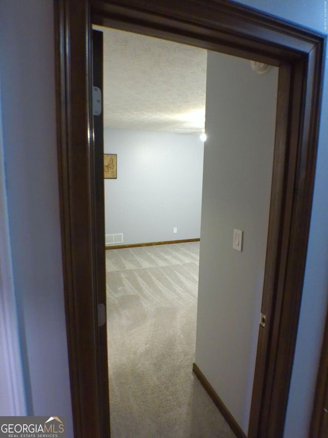 5741 Wolf Laurel Ln SW, Lilburn, GA 30047 - hallway featuring light colored carpet and baseboards
