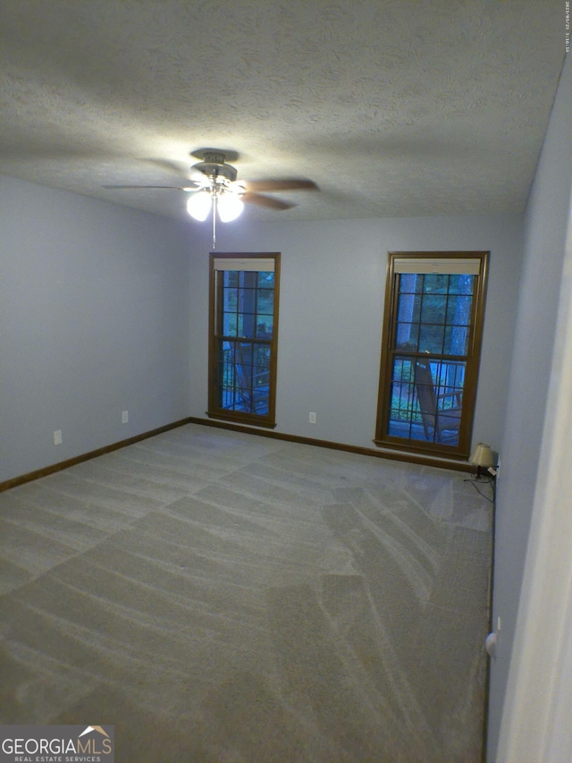 5741 Wolf Laurel Ln SW, Lilburn, GA 30047 - empty room featuring carpet floors, a ceiling fan, and a textured ceiling
