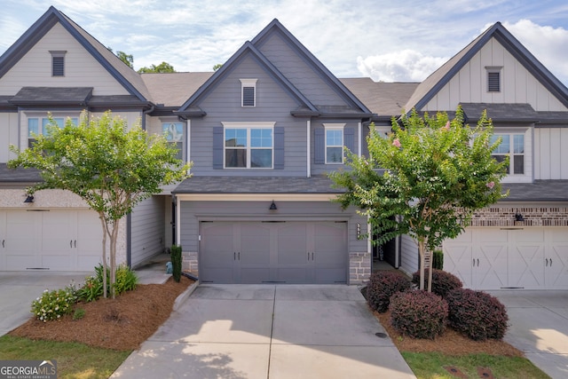 5615 Parkview Ln, Flowery Branch, GA 30542 - view of front of house with board and batten siding, a garage, and driveway