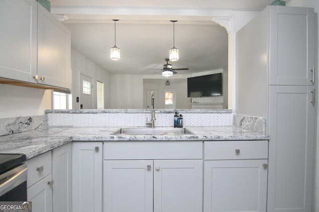 711 Main St, Byron, GA 31008 - kitchen featuring a ceiling fan, plenty of natural light, pendant lighting, and light stone countertops