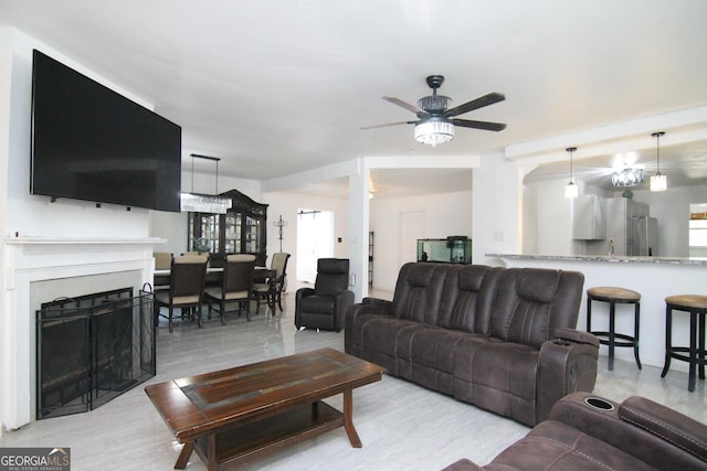 711 Main St, Byron, GA 31008 - living area with a ceiling fan, a fireplace, and light wood finished floors