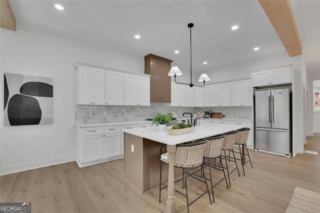 830 Gaston St SW, Atlanta, GA 30310 - kitchen with freestanding refrigerator, light wood-type flooring, decorative backsplash, an island with sink, and recessed lighting