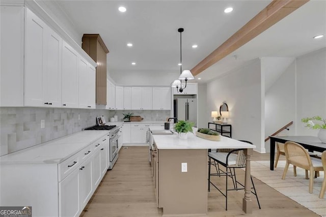 830 Gaston St SW, Atlanta, GA 30310 - kitchen with appliances with stainless steel finishes, backsplash, light wood finished floors, and recessed lighting