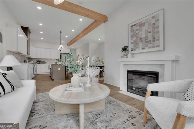 830 Gaston St SW, Atlanta, GA 30310 - living room with recessed lighting, light wood-style flooring, beam ceiling, and a fireplace with flush hearth