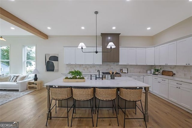 830 Gaston St SW, Atlanta, GA 30310 - kitchen featuring tasteful backsplash, white cabinetry, a breakfast bar, beamed ceiling, and recessed lighting