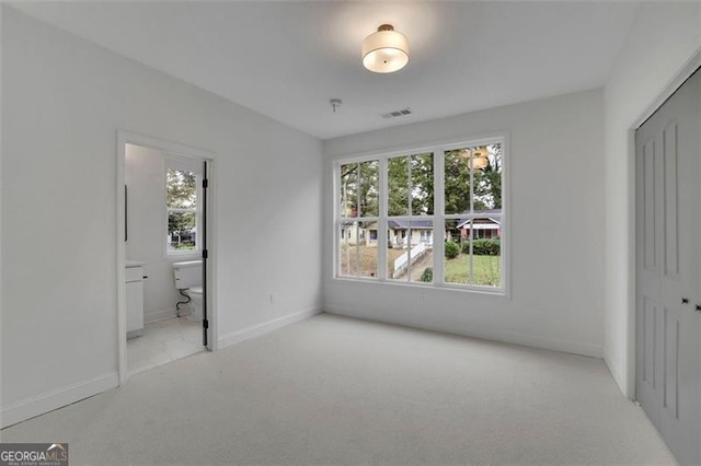 830 Gaston St SW, Atlanta, GA 30310 - unfurnished bedroom featuring multiple windows, carpet, a closet, and ensuite bathroom
