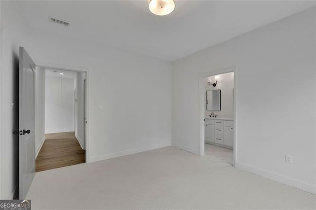830 Gaston St SW, Atlanta, GA 30310 - unfurnished bedroom with light colored carpet and connected bathroom