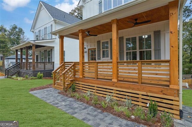 830 Gaston St SW, Atlanta, GA 30310 - view of side of property with board and batten siding, covered porch, a ceiling fan, and a lawn