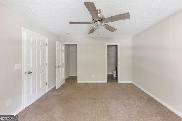 400 Rustin Dr, Dallas, GA 30157 - unfurnished bedroom featuring carpet floors, a textured ceiling, a spacious closet, ensuite bathroom, and a ceiling fan