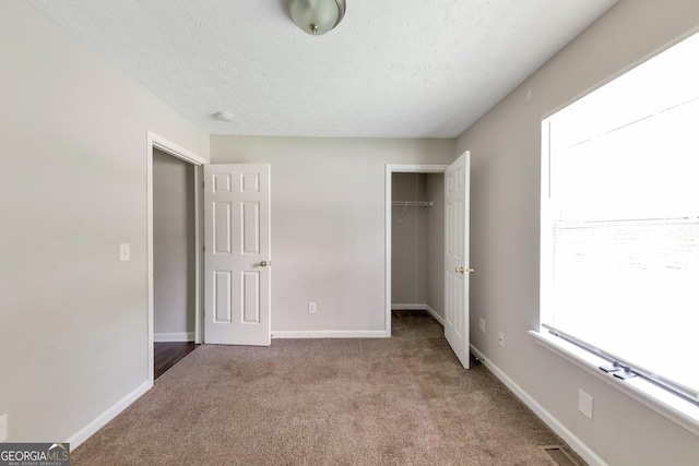 400 Rustin Dr, Dallas, GA 30157 - unfurnished bedroom featuring carpet, a textured ceiling, a closet, and a spacious closet