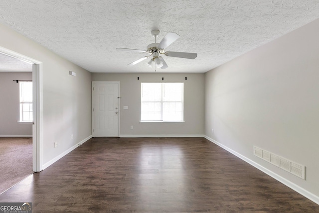 400 Rustin Dr, Dallas, GA 30157 - empty room featuring ceiling fan, dark wood-style floors, plenty of natural light, and a textured ceiling