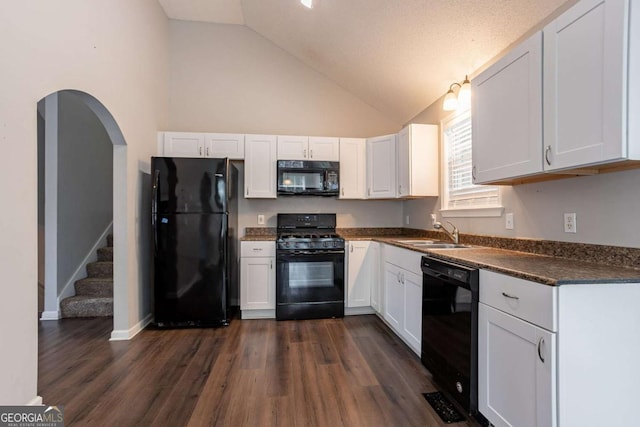 962 Taylors Farm Ct, Canton, GA 30115 - kitchen with black appliances, dark countertops, white cabinets, and high vaulted ceiling