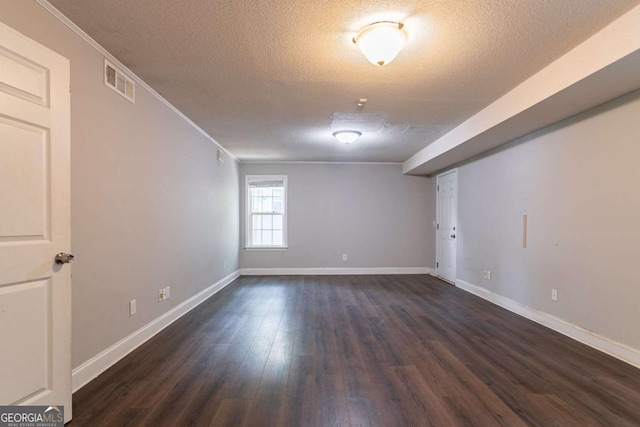 962 Taylors Farm Ct, Canton, GA 30115 - spare room with a textured ceiling, dark wood-style flooring, and ornamental molding