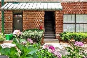 791 Wylie St SE Unit 404, Atlanta, GA 30316 - view of exterior entry featuring brick siding, a standing seam roof, and a metal roof