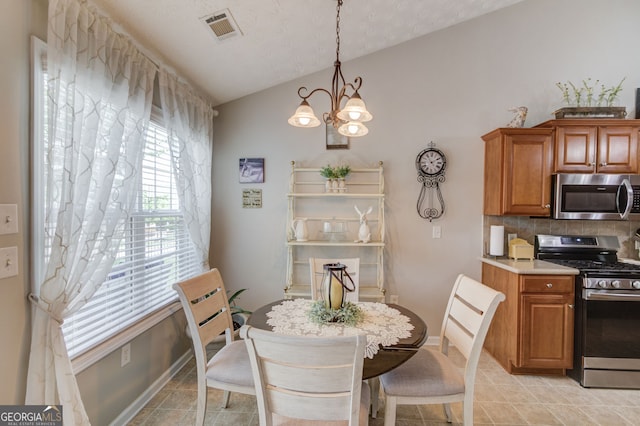 253 Lakeview Bend Cir, Jefferson, GA 30549 - dining space featuring lofted ceiling, a chandelier, and light tile patterned flooring