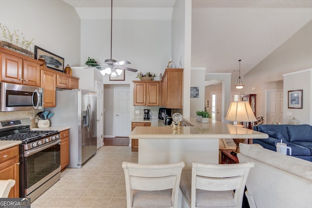 253 Lakeview Bend Cir, Jefferson, GA 30549 - kitchen with appliances with stainless steel finishes, high vaulted ceiling, open floor plan, decorative backsplash, and light countertops