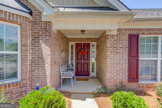 253 Lakeview Bend Cir, Jefferson, GA 30549 - view of exterior entry featuring brick siding, board and batten siding, and covered porch
