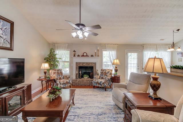 253 Lakeview Bend Cir, Jefferson, GA 30549 - living area featuring a ceiling fan, healthy amount of natural light, a fireplace, and a textured ceiling