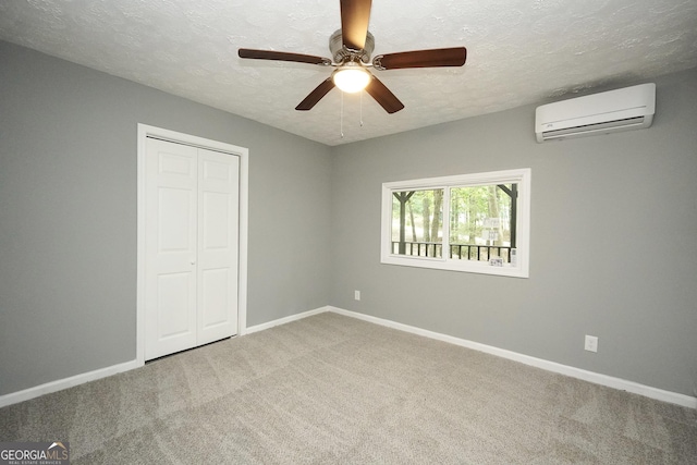 118 Turtle Cove Trwy, Monticello, GA 31064 - unfurnished bedroom with a wall unit AC, a textured ceiling, carpet flooring, a closet, and ceiling fan