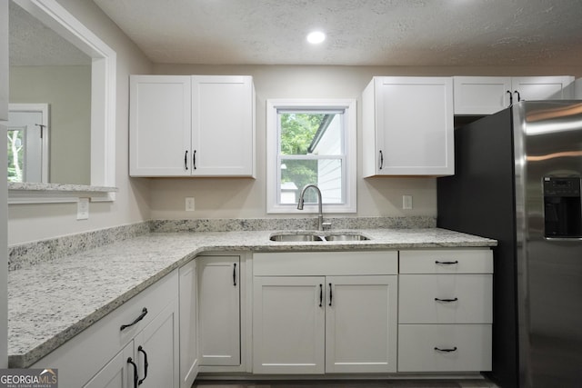 118 Turtle Cove Trwy, Monticello, GA 31064 - kitchen with stainless steel refrigerator with ice dispenser, white cabinets, a textured ceiling, light stone countertops, and recessed lighting