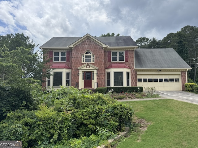 25 Darcee Ct, Lawrenceville, GA 30046 - view of front of property with an attached garage, concrete driveway, brick siding, and a front lawn