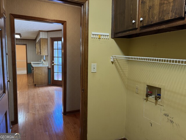25 Darcee Ct, Lawrenceville, GA 30046 - laundry room featuring cabinet space, hardwood / wood-style flooring, hookup for a washing machine, and ornamental molding