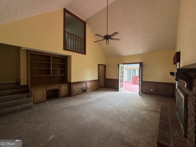 25 Darcee Ct, Lawrenceville, GA 30046 - unfurnished living room featuring high vaulted ceiling, wainscoting, a brick fireplace, carpet flooring, and ceiling fan