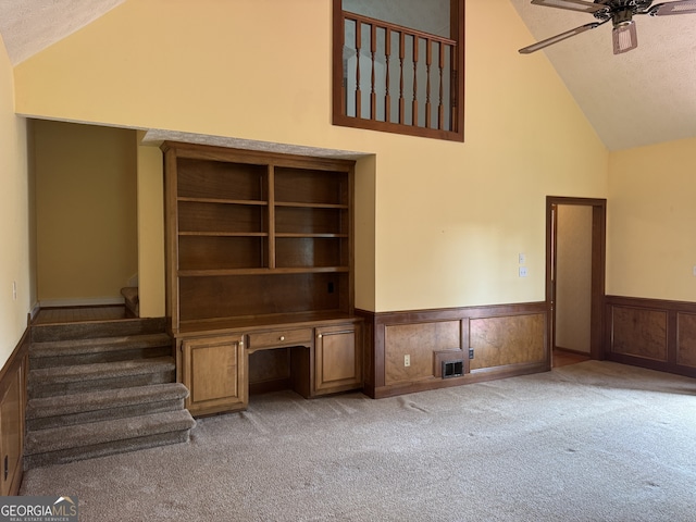 25 Darcee Ct, Lawrenceville, GA 30046 - unfurnished living room featuring high vaulted ceiling, a wainscoted wall, ceiling fan, carpet floors, and a textured ceiling