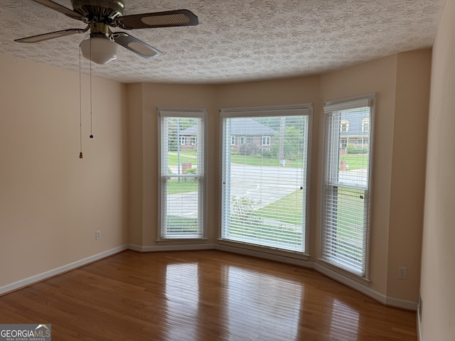 25 Darcee Ct, Lawrenceville, GA 30046 - unfurnished dining area with wood finished floors, ceiling fan, and a textured ceiling