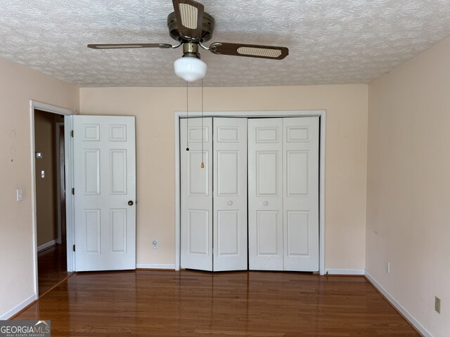 25 Darcee Ct, Lawrenceville, GA 30046 - unfurnished bedroom with wood finished floors, a textured ceiling, a closet, and ceiling fan