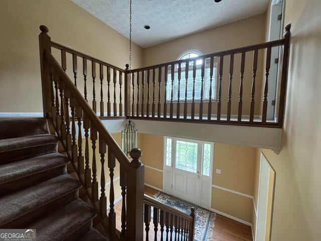 25 Darcee Ct, Lawrenceville, GA 30046 - stairs with a textured ceiling and wood finished floors