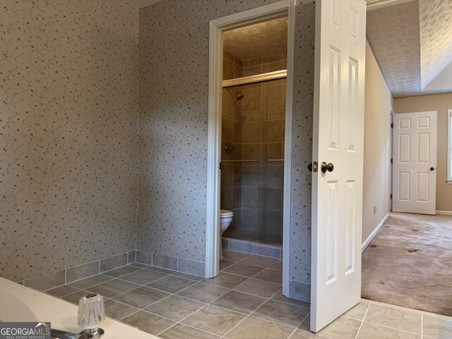25 Darcee Ct, Lawrenceville, GA 30046 - full bathroom featuring tile patterned floors, a stall shower, wallpapered walls, and a textured ceiling