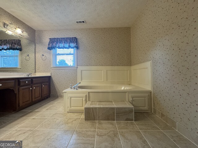25 Darcee Ct, Lawrenceville, GA 30046 - bathroom featuring wallpapered walls, vanity, a garden tub, and a textured ceiling