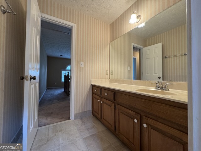 25 Darcee Ct, Lawrenceville, GA 30046 - bathroom with wallpapered walls, vanity, and a textured ceiling