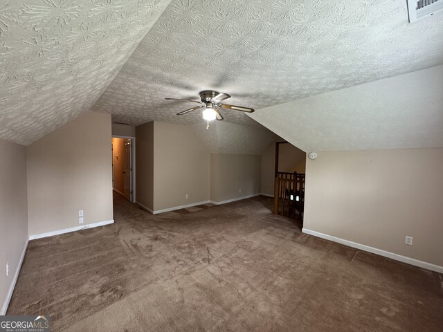 25 Darcee Ct, Lawrenceville, GA 30046 - bonus room featuring carpet, ceiling fan, lofted ceiling, and a textured ceiling