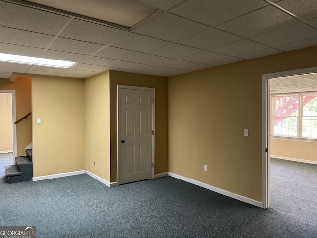 25 Darcee Ct, Lawrenceville, GA 30046 - unfurnished room featuring dark colored carpet, a paneled ceiling, and stairs