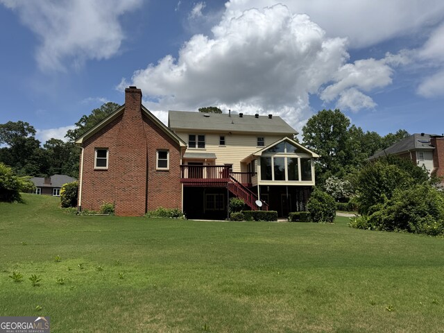 25 Darcee Ct, Lawrenceville, GA 30046 - rear view of property with a sunroom, a chimney, a yard, and stairway