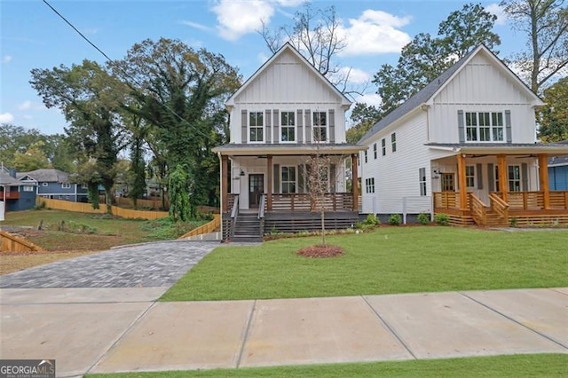 826 Gaston St SW, Atlanta, GA 30310 - view of front facade with covered porch, board and batten siding, a front lawn, and stairway