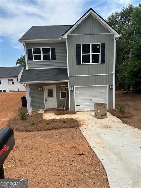 23 Taylor St, Toccoa, GA 30577 - view of front of home with driveway, a garage, and board and batten siding