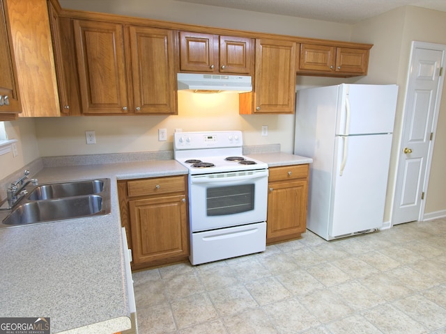 13 Pine Shadow Ct, Centerville, GA 31028 - kitchen with white appliances, under cabinet range hood, brown cabinets, and light countertops