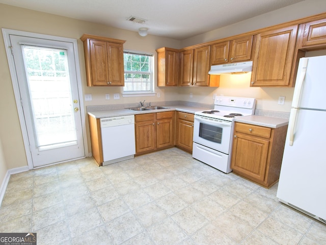 13 Pine Shadow Ct, Centerville, GA 31028 - kitchen with white appliances, under cabinet range hood, light countertops, and brown cabinetry