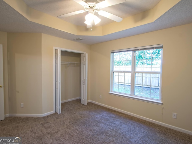 13 Pine Shadow Ct, Centerville, GA 31028 - unfurnished bedroom featuring carpet floors, a tray ceiling, a closet, and a ceiling fan