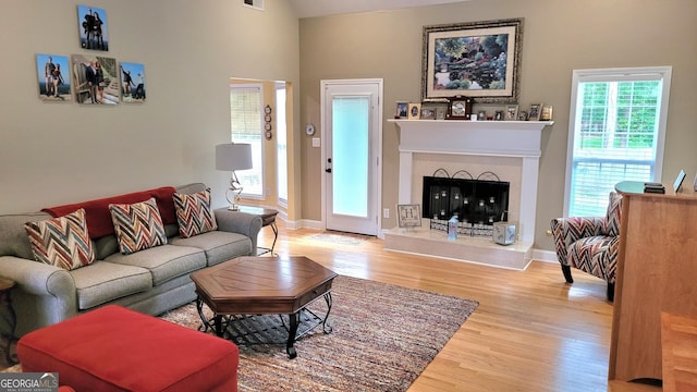 223 Overland Trl, Mcdonough, GA 30252 - living room with wood finished floors and a fireplace with raised hearth